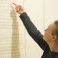 Graduating art history student Linnea Lois Hodge oversees installation of Lovis Corinth works at the Block.