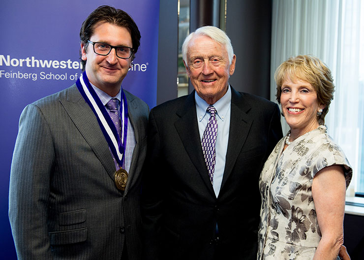 Michael Terry, who holds the inaugural Dr. Charles and Leslie Snorf Professorship in Orthopaedic Surgery, stands with benefactors Charles R. Snorf ’58 MD, ’63 GME and Leslie Snorf at a May 24, 2016, investiture ceremony 