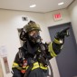 A firefighter in uniform pointing