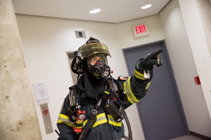 A firefighter in uniform pointing