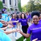 Students high five one another