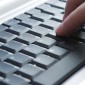 A hand on a computer keyboard