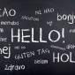 The world "Hello" is written on a chalkboard in several languages