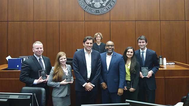 From left: Lane Lansdown, JD ’18, Hannah Freiman JD ’18, Coach Mark Duric, Coach Kendrick Washington, Amanda Tzivas JD ’19 and Joey Becker JD ’18. Judge Rebecca Pallmeyer, who presided over the final round, is in the background. The team will compete in January at the national labor law championship.