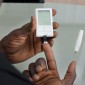 A man pricks his finger with a glucose meter to test his blood-sugar level. 
