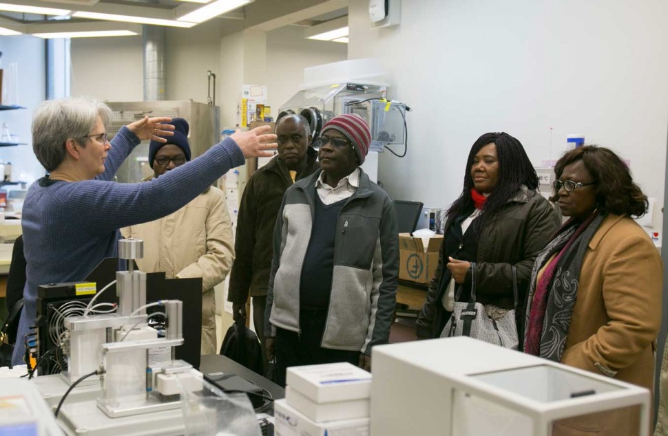 Sally McFall (far left) gives a tour of the Center for Innovation in Global Health Technologies. (Photo by Morgan Searles)