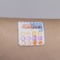 A colorful sticker on a sweaty arm