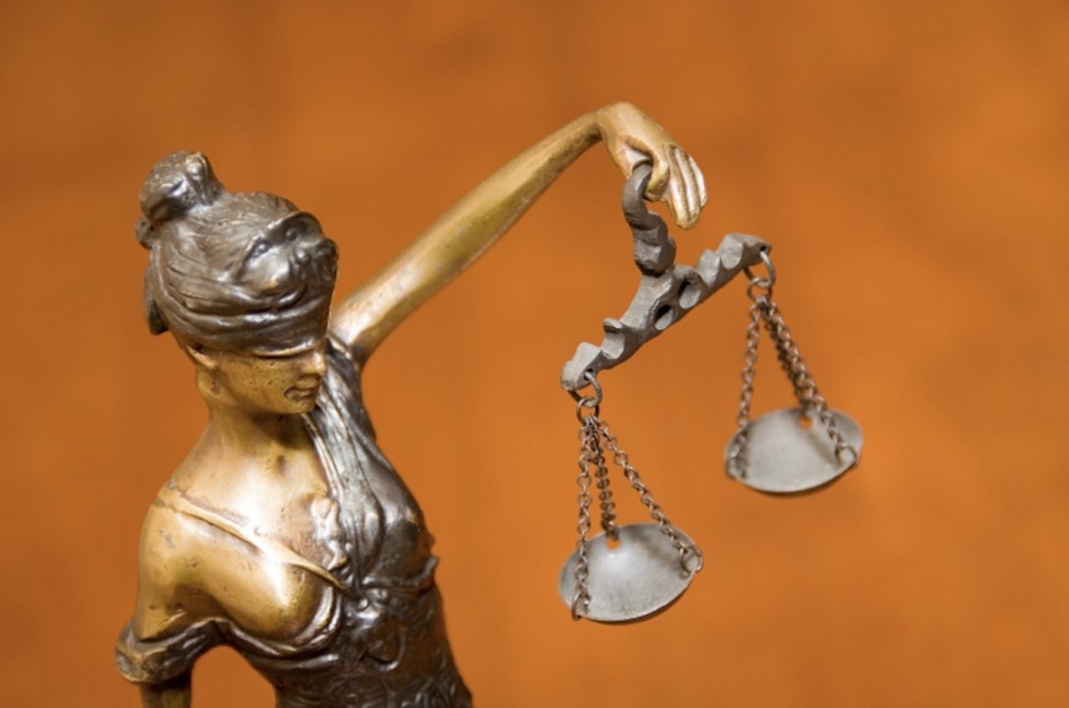 A statue of a woman holding the scales of justice