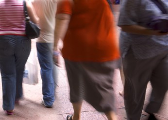 Overweight people walking on a sidewalk