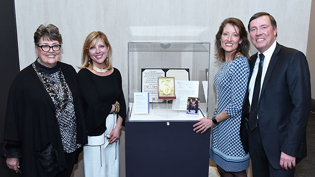 Image of Mortensen family with Nobel prize medal