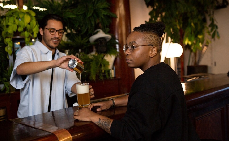 Photo of someone pouring someone else a beer at a bar