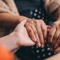 Image of two people holding hands