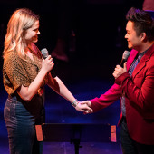 Songwriters from the 2019 program hold hands while singing
