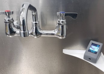 Image of the opal handwashing device next to a sink