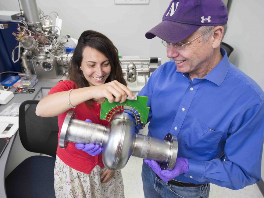 SQMS Director Anna Grassellino and Deputy Director James Sauls hold a superconducting radio-frequency cavity inside the Material Science Lab at the Department of Energy’s Fermi National Accelerator Laboratory. Credit: Reidar Hahn, Fermilab
