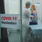a stock image showing a woman getting vaccinated