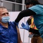 A frontline worker receives a COVID-19 vaccine.