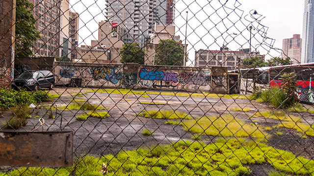 Northwestern researchers studying firearms violence call for preventive interventions in blighted urban communities where it’s easy to obtain guns and find places to hide them. fenced urban lot with graffiti