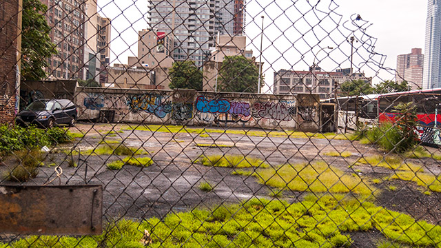 fenced urban lot with graffiti