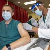 A doctor at Walter Reed National Military Medical Center, receives a COVID-19 vaccination. Department of Defense photo by Lisa Ferdinando courtesy of Flickr.
