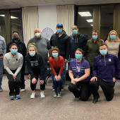 Group poses in vaccine clinic