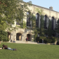Students on grass in front of library