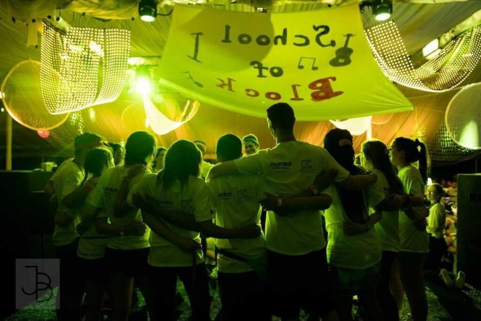 students arm in arm in the Dance Marathon tent