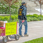 Parent with child at a vaccine rally