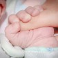 Baby holding adult finger
