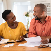 Smiling couple working on a budget