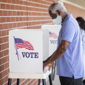 man votes in 2020 presidential election with a mask on
