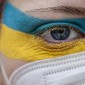 an illustration showing a face painted with the colors of the ukrainian flag