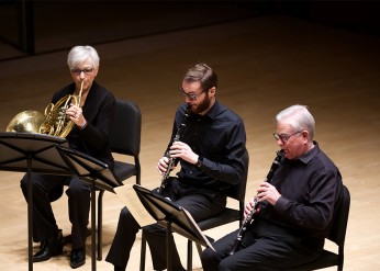 French horn player and two clarinetists