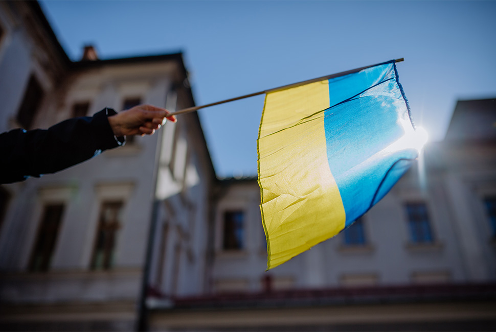 A hand holding the Ukraine flag.