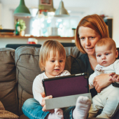 Mom looking at screen with kids