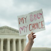 Protest sign in front of Supreme Court