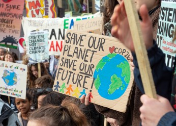People holding signs at a climate march advocating climate action