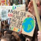 People holding signs at a climate march advocating climate action