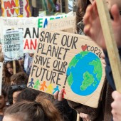 People holding signs at a climate march advocating climate action