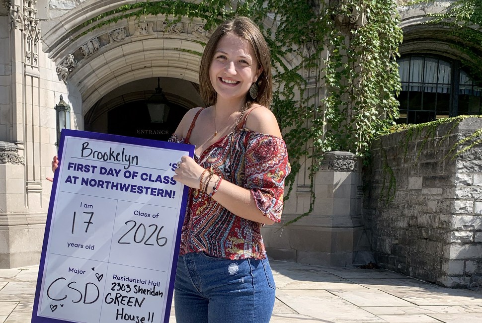 Undergraduate student holding a sign with name and class year