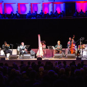 Drummer Makaya McCraven, harpist Brandee Younger and other guests performing live on stage.