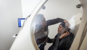 A simulated study participant uses a bod pod in the Longevity Lab (Photo by Shane Collins, Northwestern University)
