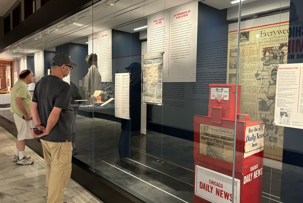 Visitors to the Mike Royko exhibit look at an honor box and printing plate