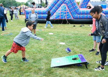 A child plays corn hole 