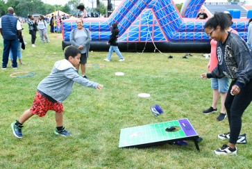 A child plays corn hole 