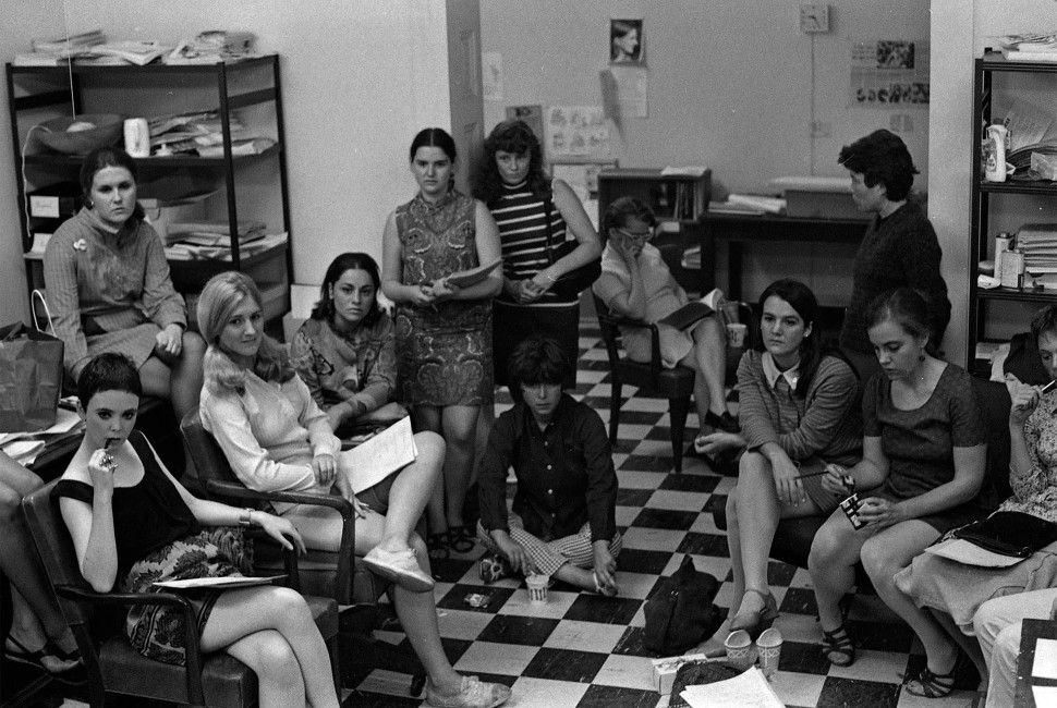 A black-and-white photograph of New York Radical Women organizers sitting in a meeting