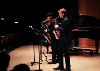 two saxophonists play on stage