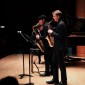 two saxophonists play on stage