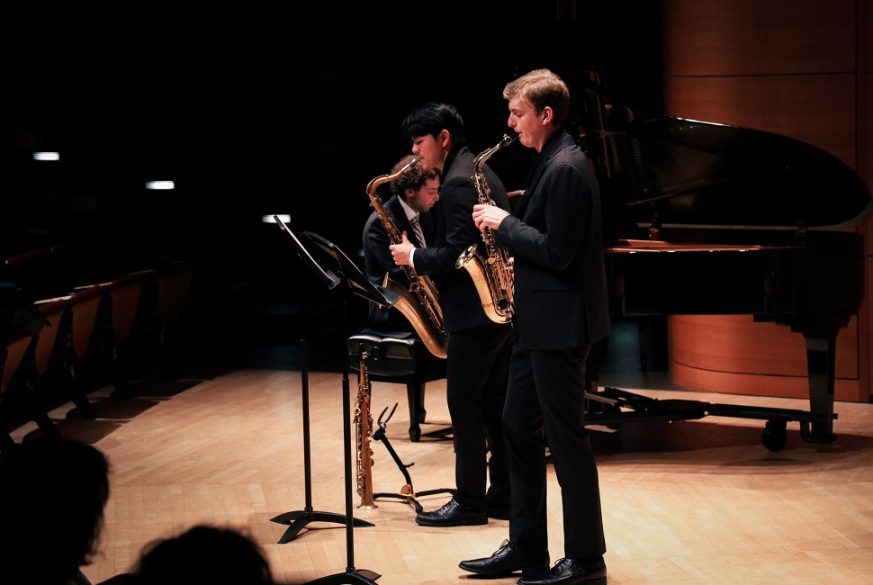 two saxophonists play on stage