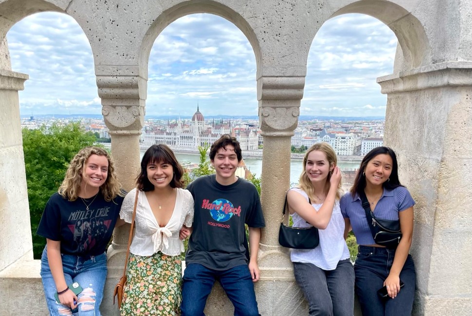 Students pose in front of the Budapest skyline